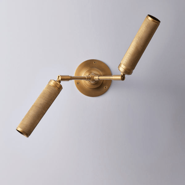 Pooky - Quantum Double Wall Light - Antiqued Brass featuring knurled details and dual spotlights.