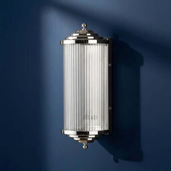 Pooky - Deco Baby Roddy ip44 rated Wall Light - Nickel with Glass Rods on a blue wall.