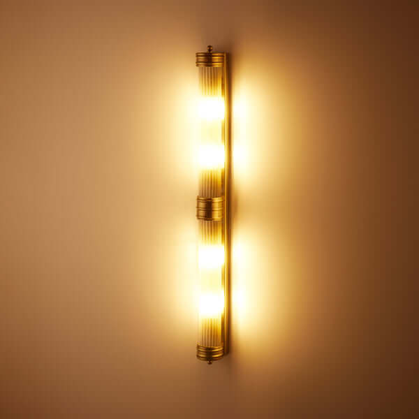 Pooky - Rodtastic ip44 Wall Light - Brass and Frosted Glass illuminating a wall with warm light.
