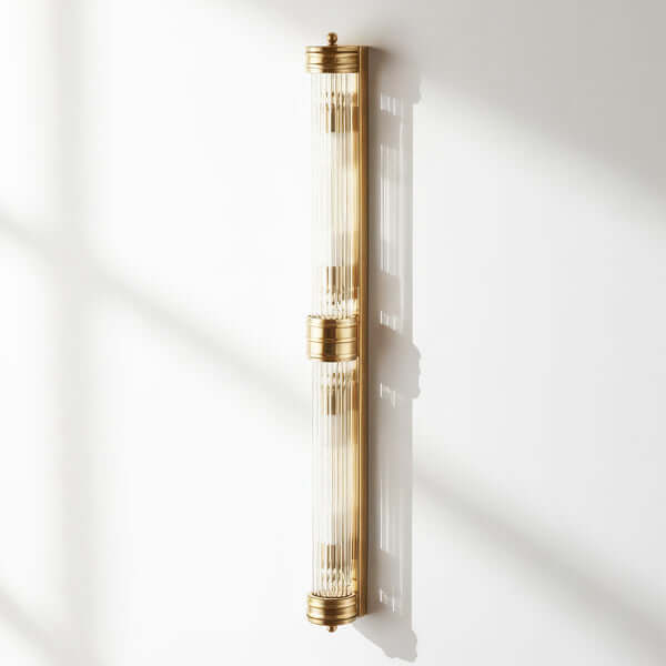 Pooky - Rodtastic ip44 Wall Light - Brass with Glass Rods elegantly illuminating a wall.