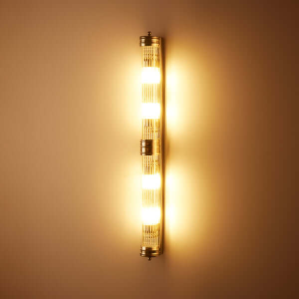 Pooky - Rodtastic ip44 Wall Light - Nickel and Glass illuminating a wall with three warm lights.