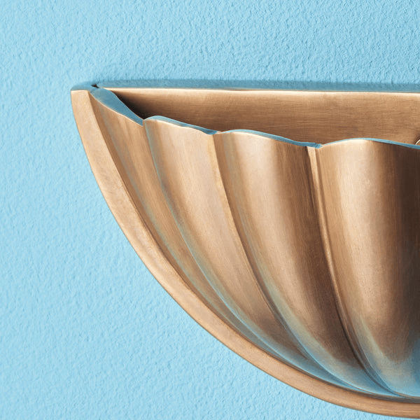 Pooky - St Jacques Wall Light - Smaller - Brass wall sconce on a blue wall with scallop shell design.