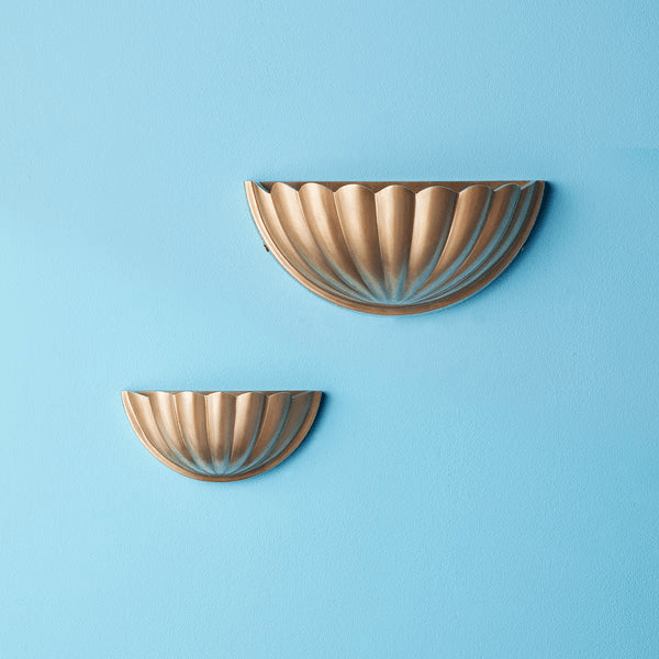 Pooky - St Jacques Wall Light - Smaller - Brass on a blue wall, showcasing a scallop shell design in cast brass.