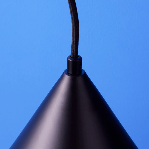 Pooky - Sway Wall Light - Black close-up view of the hanging black lampshade against a blue background.