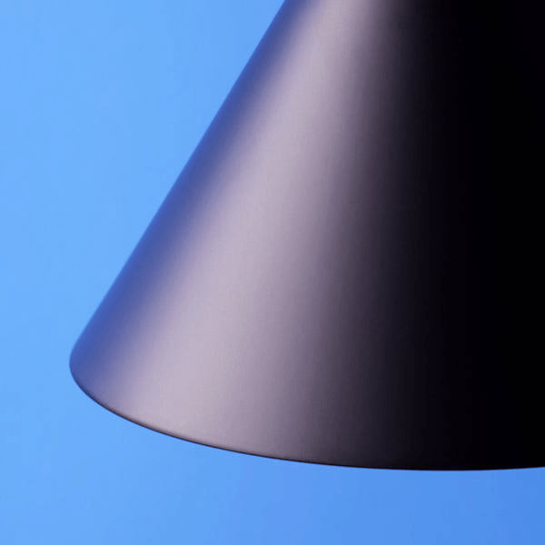 Pooky - Sway Wall Light - Black showing a sleek, black conical lamp design against a blue background.