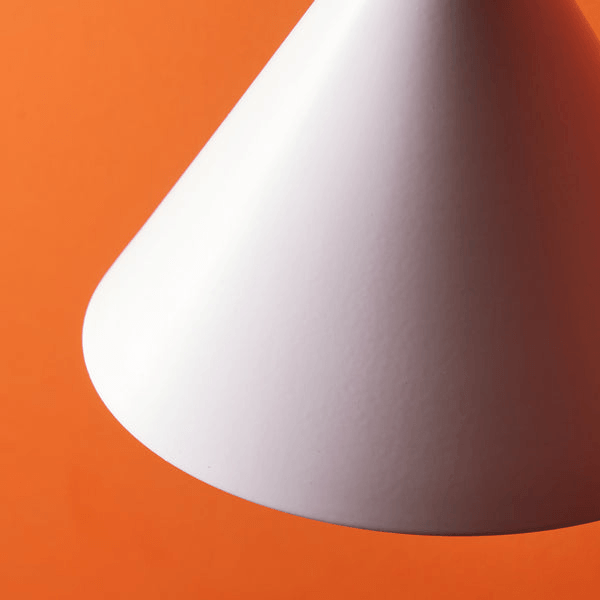Pooky - Sway Wall Light - White - stylish white lamp shade set against an orange background.
