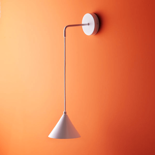Pooky - Sway Wall Light - White mounted on an orange wall with a sleek, simple design.