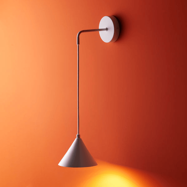 Pooky - Sway Wall Light - White hanging on an orange wall, showcasing its modern design and bright finish.
