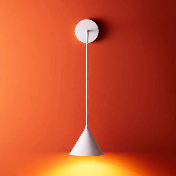 Pooky - Sway Wall Light - White hanging pendant on orange wall with bright white design.