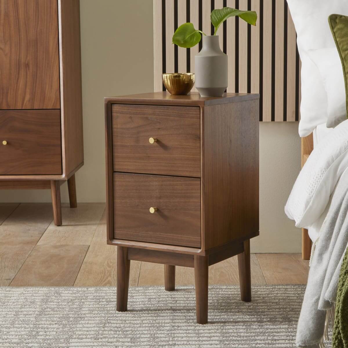 Fishe & Lilly Wright Narrow Walnut Bedside Table. Premium solid walnut 2-drawer nightstand with brass knobs in a modern bedroom.