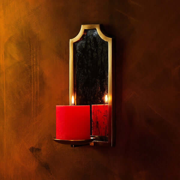 Pooky - Kite Wall Mounted Candle Holder - Antiqued Brass with red pillar candles flickering.