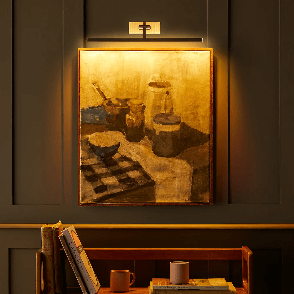 Pooky - Blake Dimmable Picture Light - Medium - Brushed Chrome Finish illuminating a painting in a stylish interior.