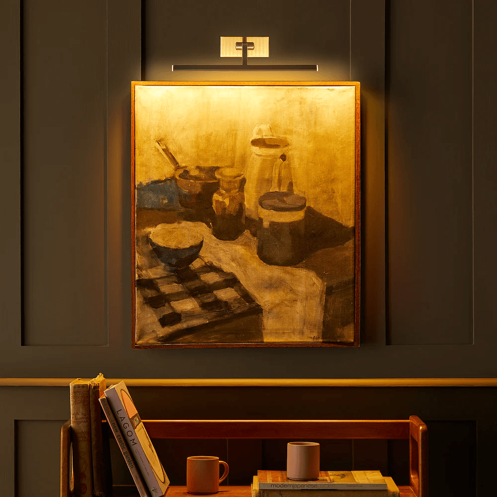 Pooky - Blake Dimmable Picture Light - Smaller - Brushed Chrome Finish illuminating a painting on a wall.