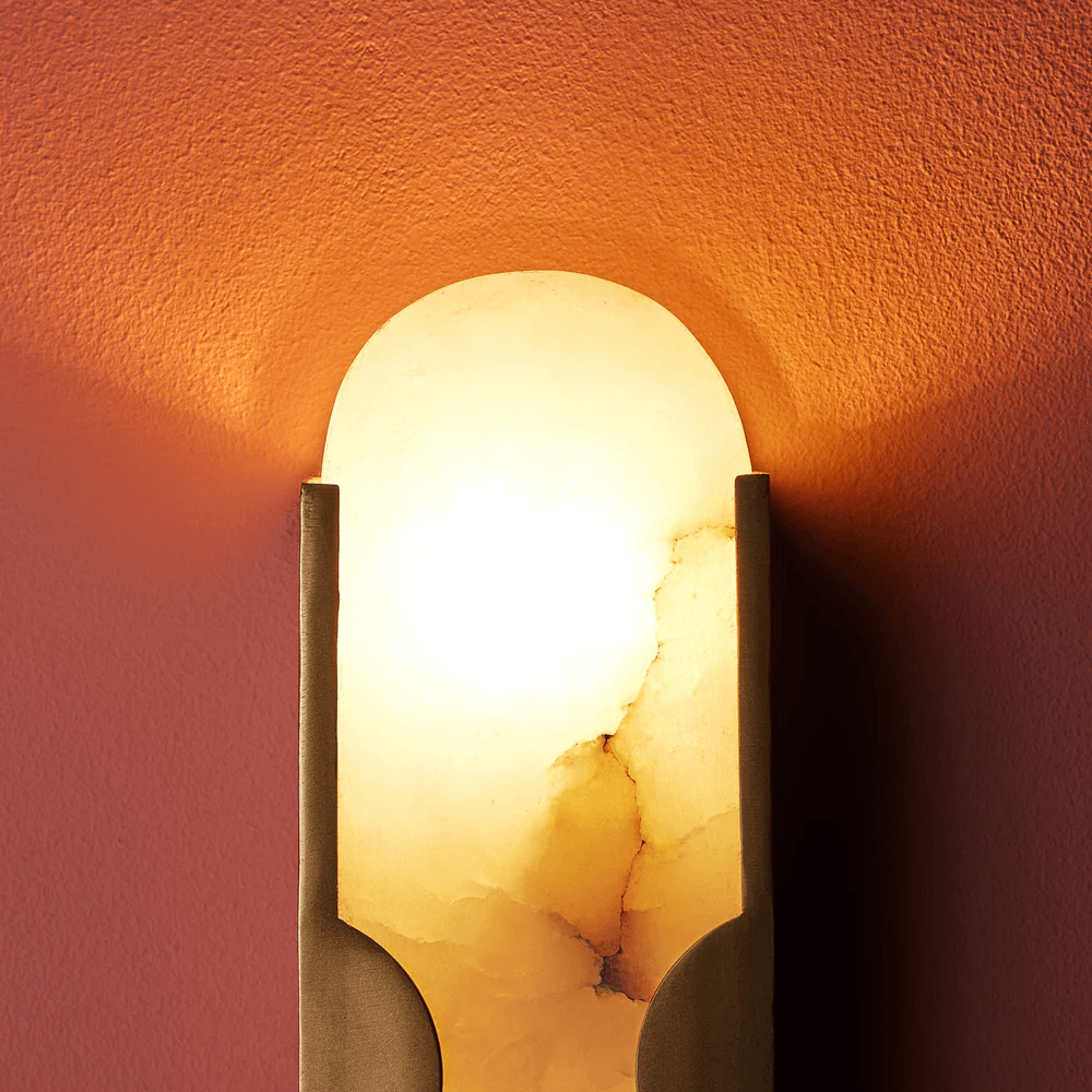 Pooky - Epicurus Alabaster Wall Light illuminating a textured wall in warm tones.