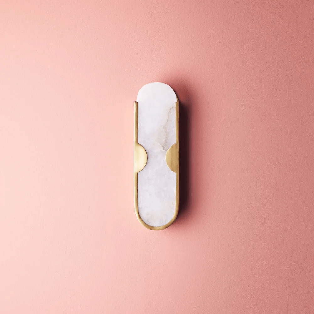 Pooky - Epicurus Alabaster Wall Light mounted on a pink wall, showcasing its elegant alabaster and brass design.