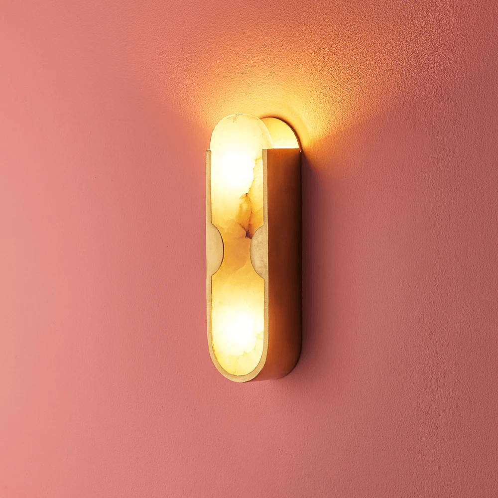 Pooky - Epicurus Alabaster Wall Light illuminating a pink wall with its elegant alabaster and brass design.