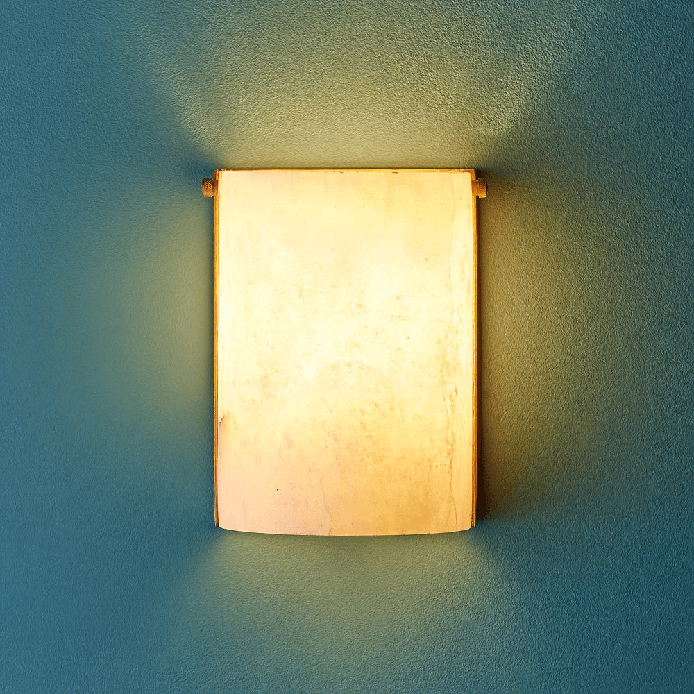 Pooky - Zeno Alabaster Wall Light illuminating a wall with its unique alabaster design.