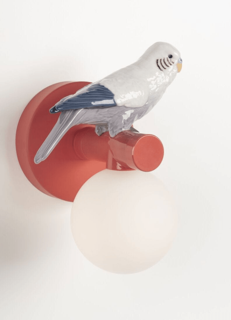 Lladró - Parrot Wall Sconce - Red with porcelain parrot figurine and globe light, showcasing coral and red finish.