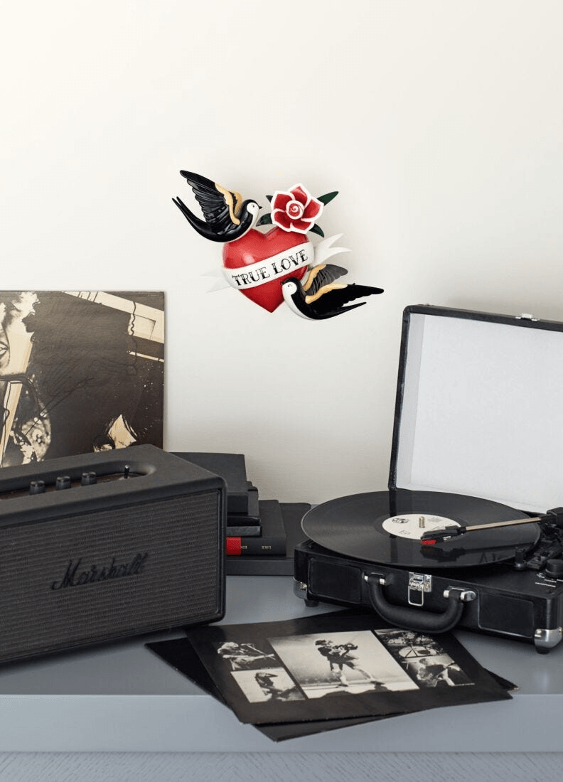 Lladró - True love Heart Figurine displayed among a vintage record player and vinyl records.