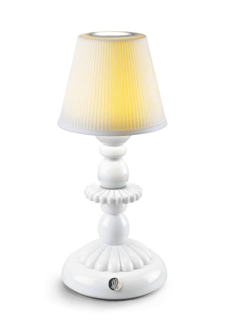 Lladró - Lotus Firefly Table Lamp - White showcasing porcelain design with a soft yellow light.
