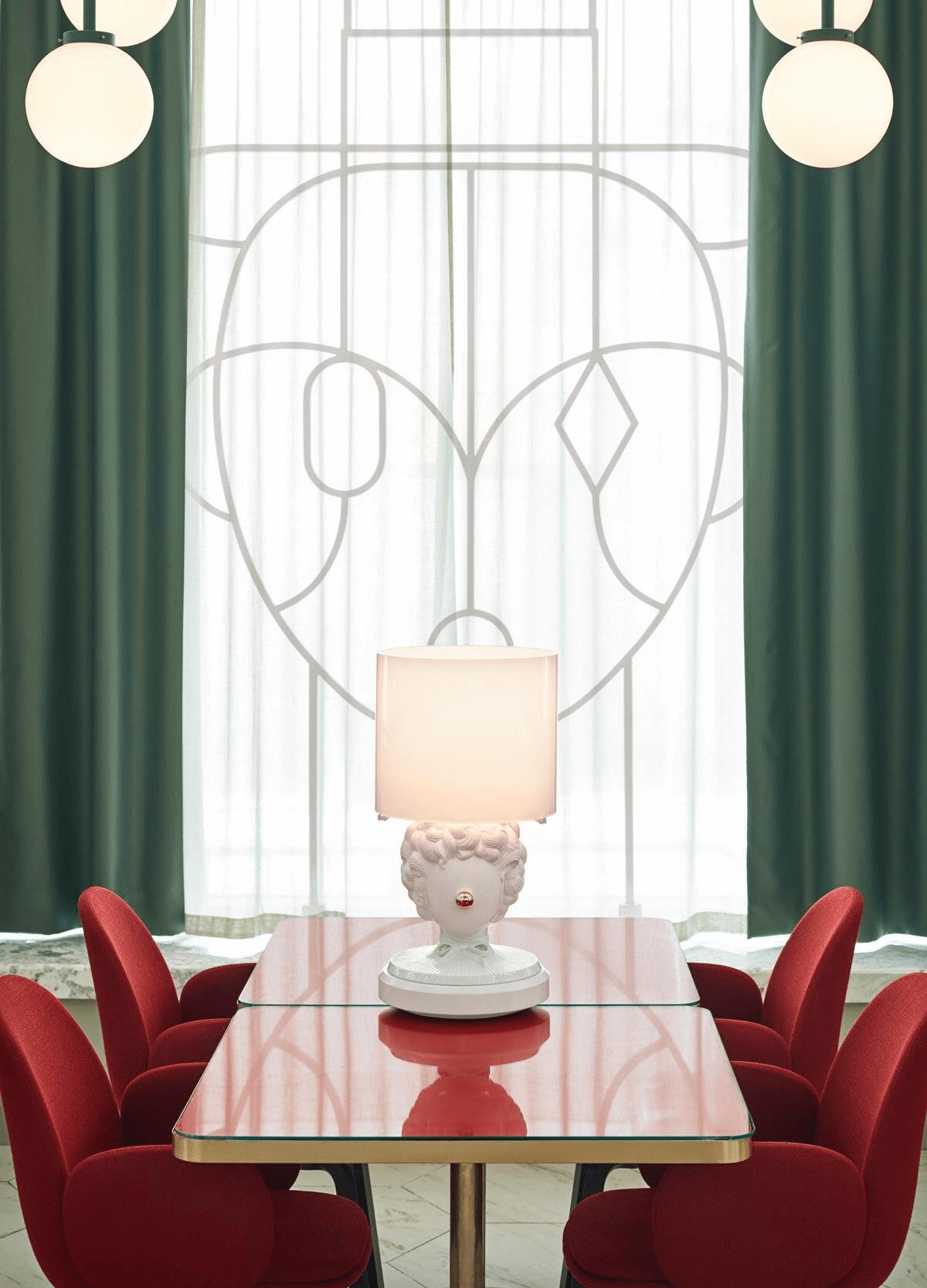 Lladró - The Clown Table Lamp on a red table. An elegant white Porcelain Lladro lamp shaped like a clown head.