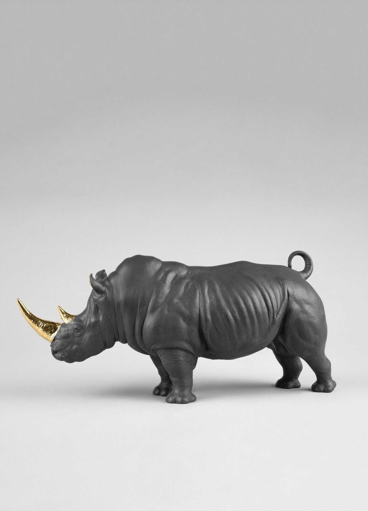 Lladró - Rhino Sculpture - Black-gold - Limited Edition in matte black porcelain with golden luster details.