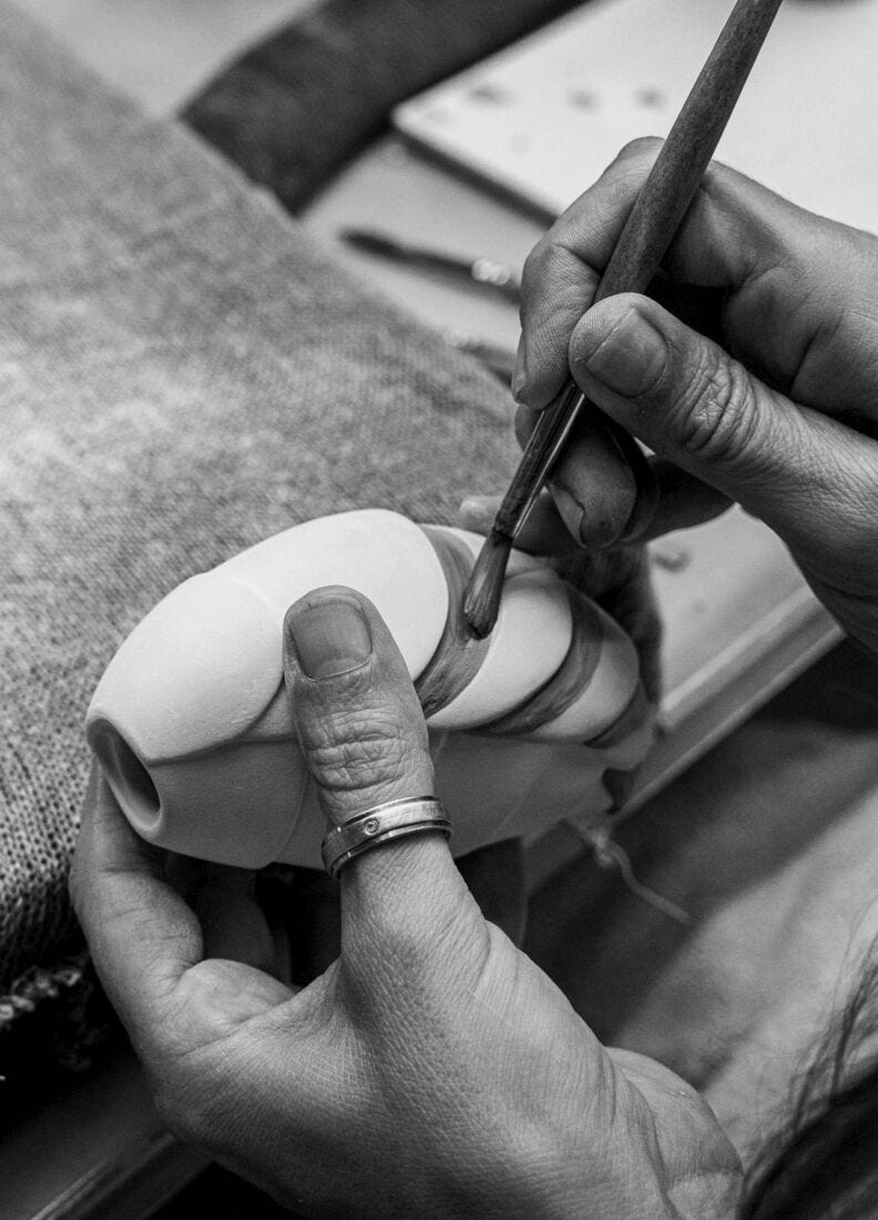 Artist detailing a Lladró - Bee Sculpture made from porcelain, showcasing fine craftsmanship.