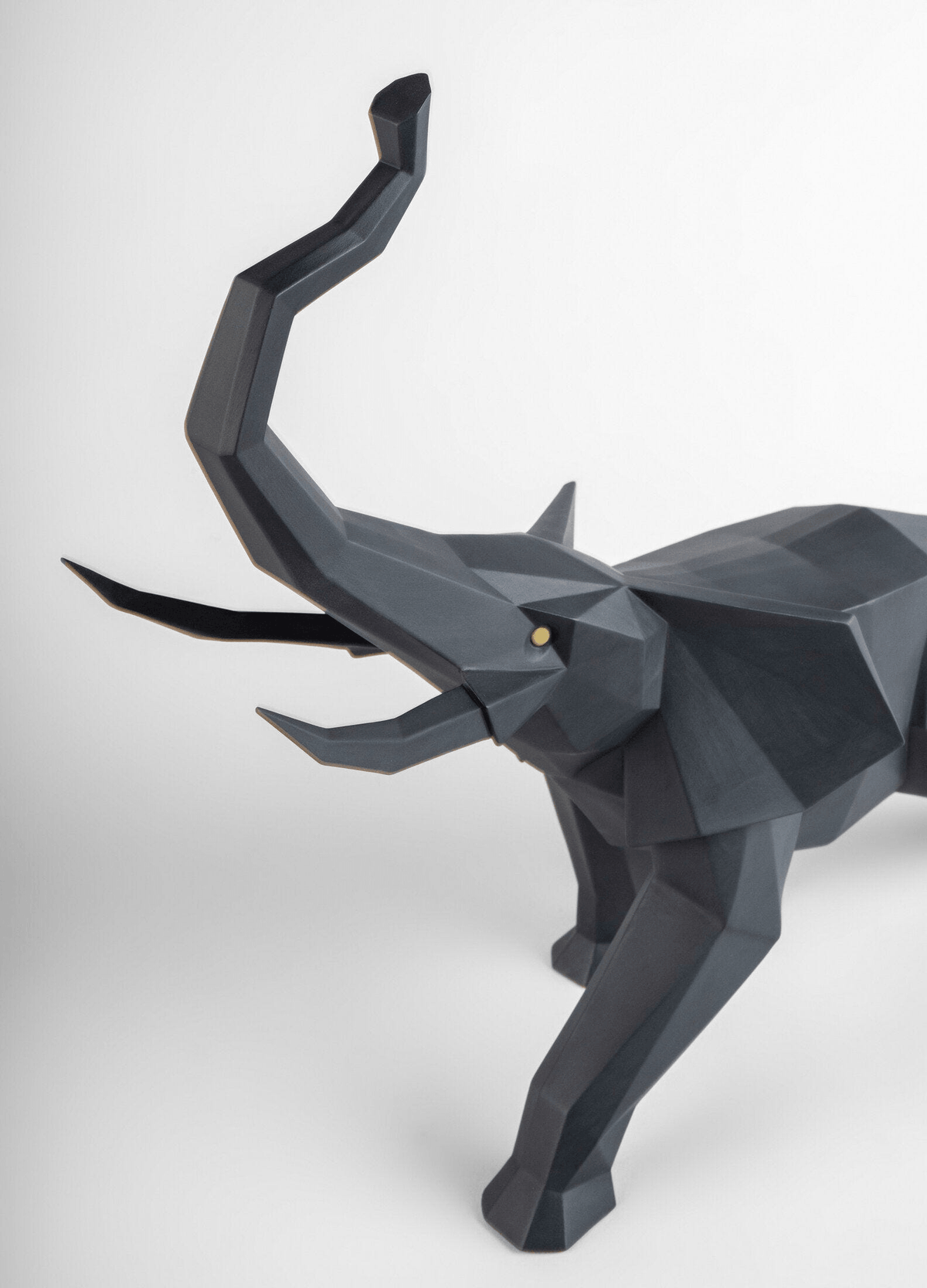 Lladró - Elephant Sculpture - Black matte, a striking porcelain representation of an elephant with its trunk raised.