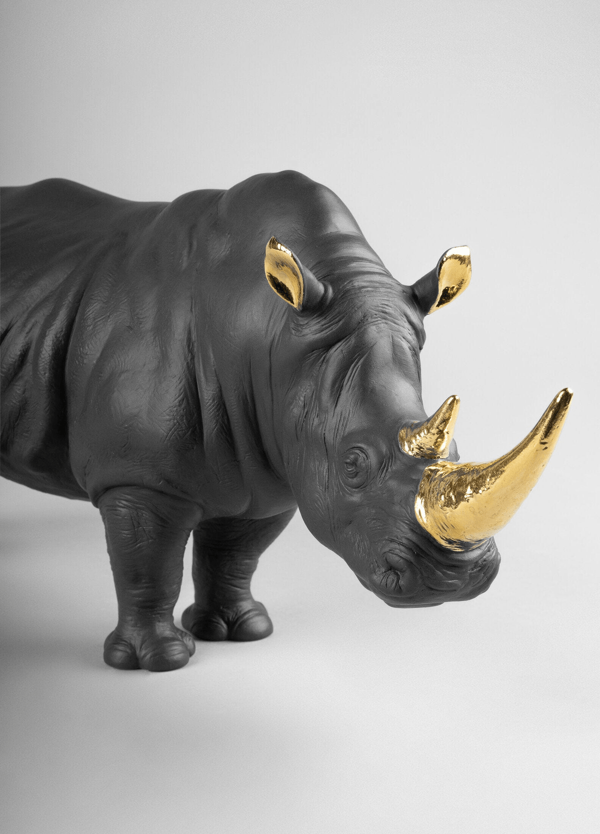 Lladró - Rhino Sculpture - Black-gold - Limited Edition, handcrafted porcelain with golden accents.