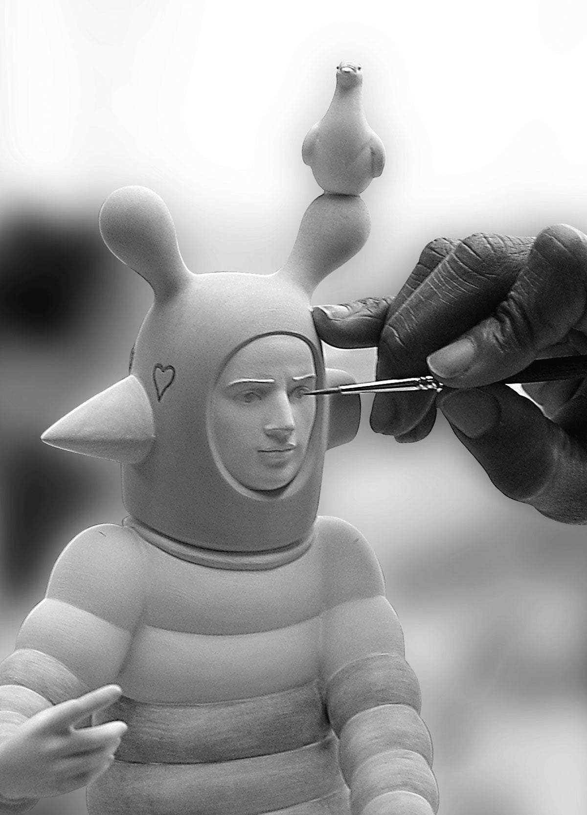 Artisan painting details on Lladró - The Lover I Sculpture, a unique porcelain creation by Jaime Hayon.