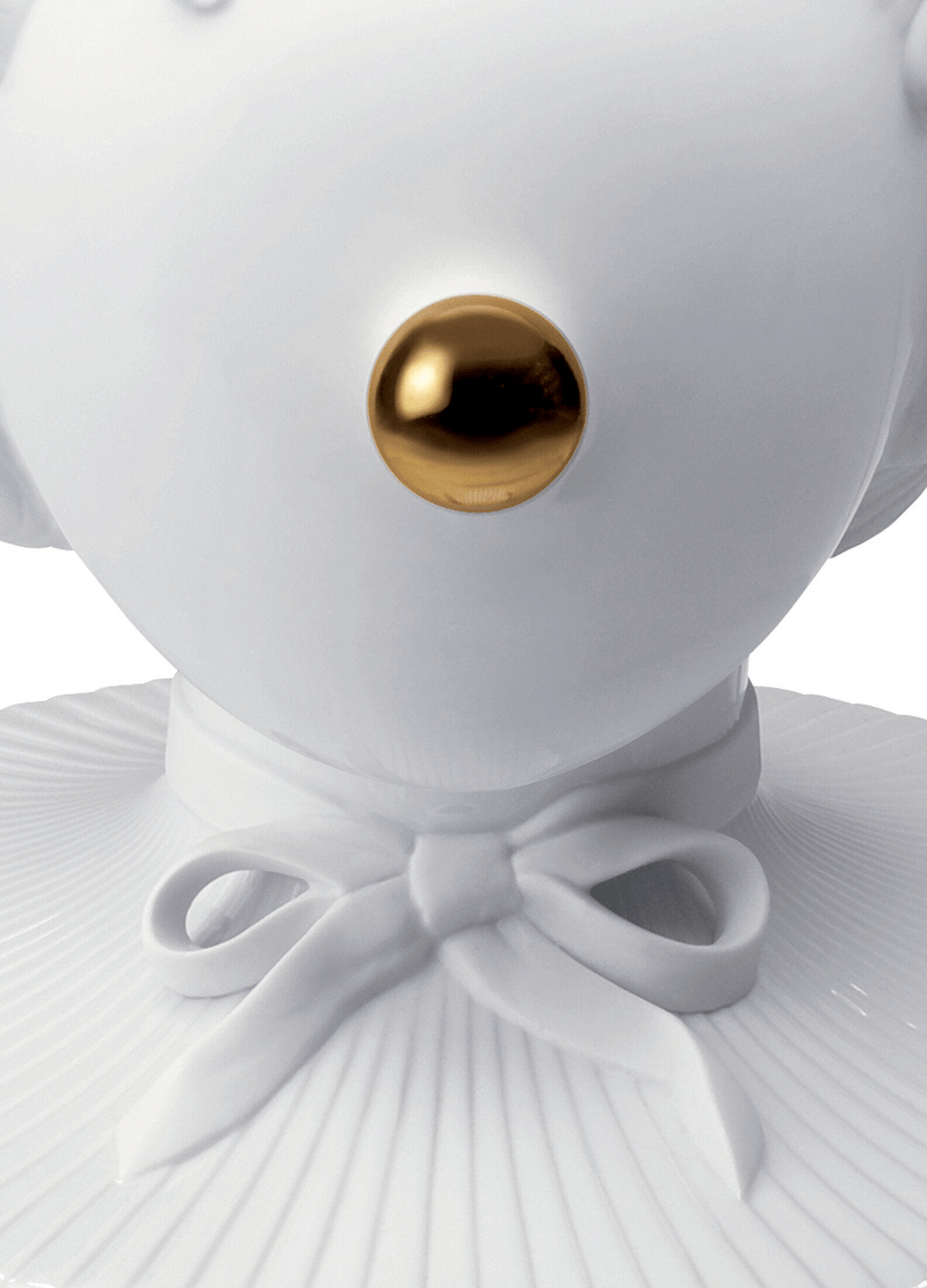 White Lladro Porcelain detail of the Lladró - The Clown Table Lamp, featuring a golden nose and sculpted bow tie.