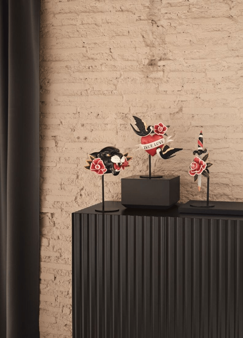 Lladró - True love Heart Figurine displayed on a black surface, featuring detailed tattoos in porcelain.