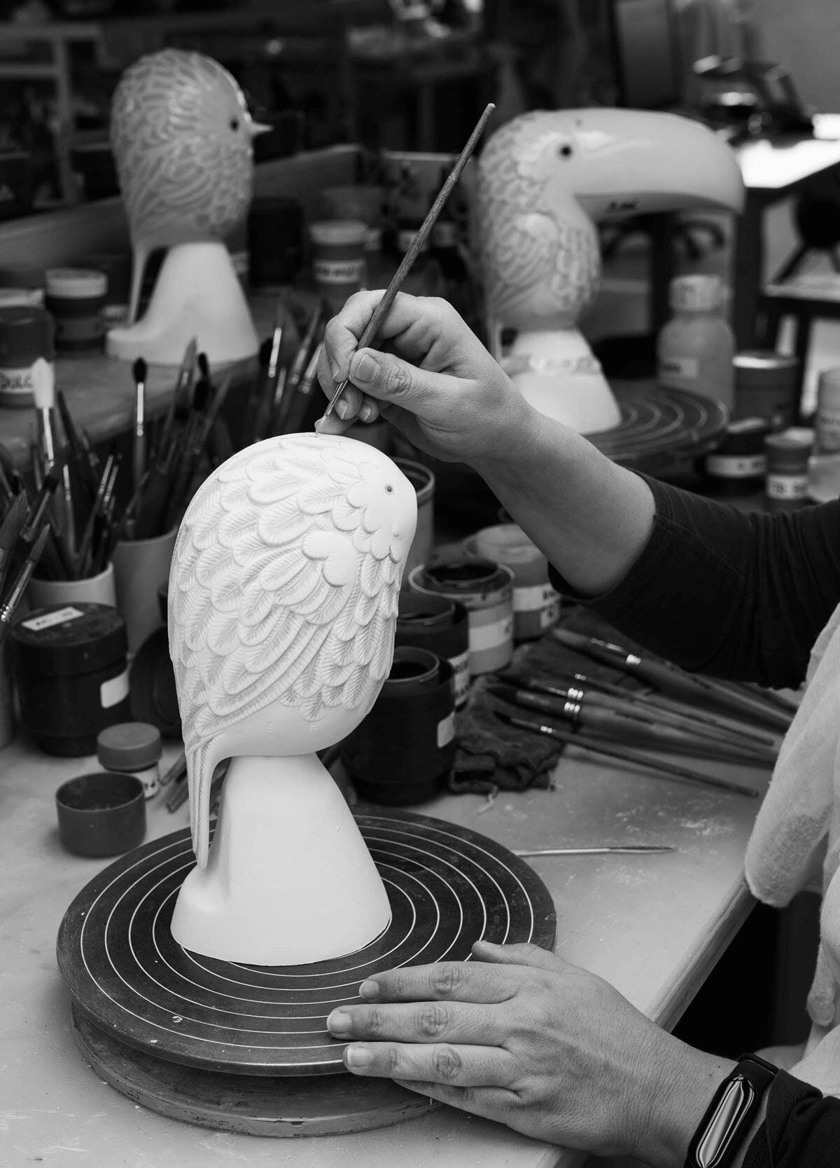 Artist painting Lladró - Face 2 Face - Toucan porcelain bird sculpture in a workshop