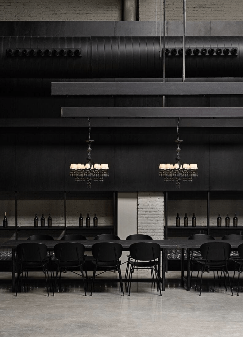 Lladró - Belle de Nuit 12 Lights Chandelier - Absolute Black hanging in a modern black interior setting.