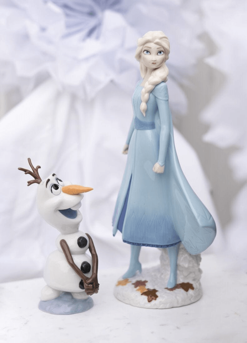 Lladró - Elsa Figurine displayed with Olaf, both made of glazed porcelain, showcasing signature colors and detail.