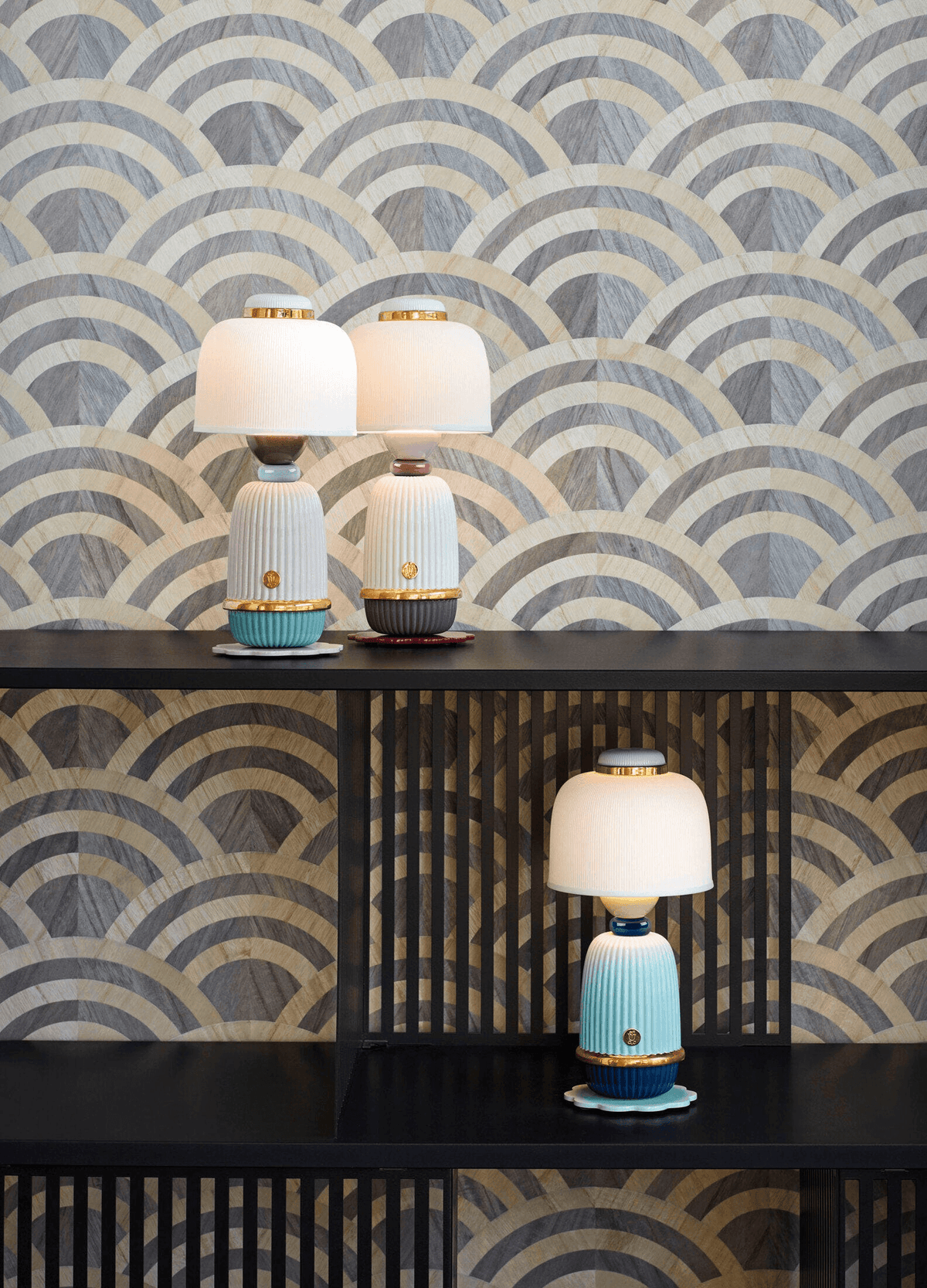 Porcelain Lladro lighting display featuring the cordless Lladró - Kokeshi lamp - Pink on a black shelf.