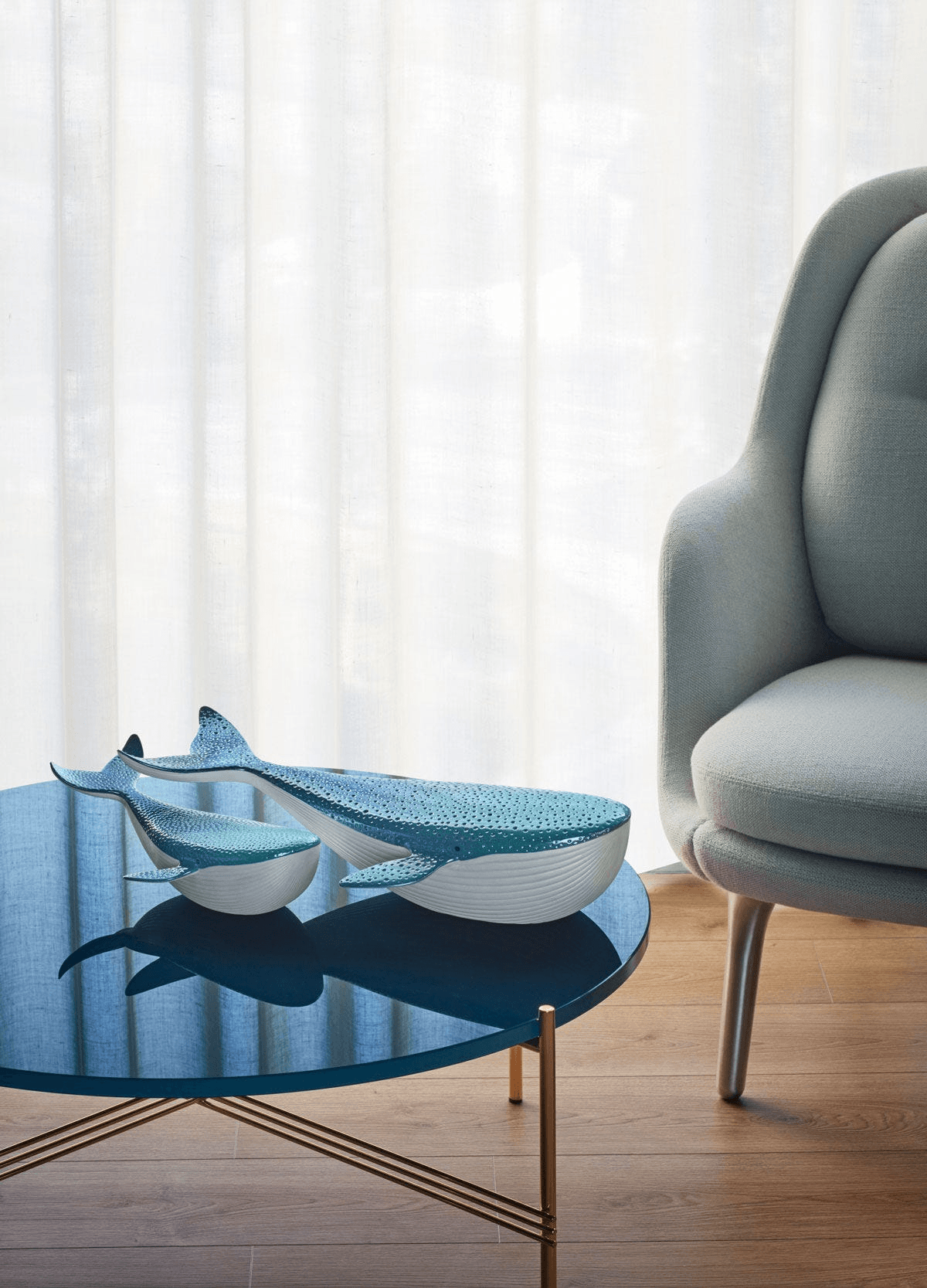 Lladró - Whale porcelain decorative pieces displayed on a modern coffee table in a stylish living room.