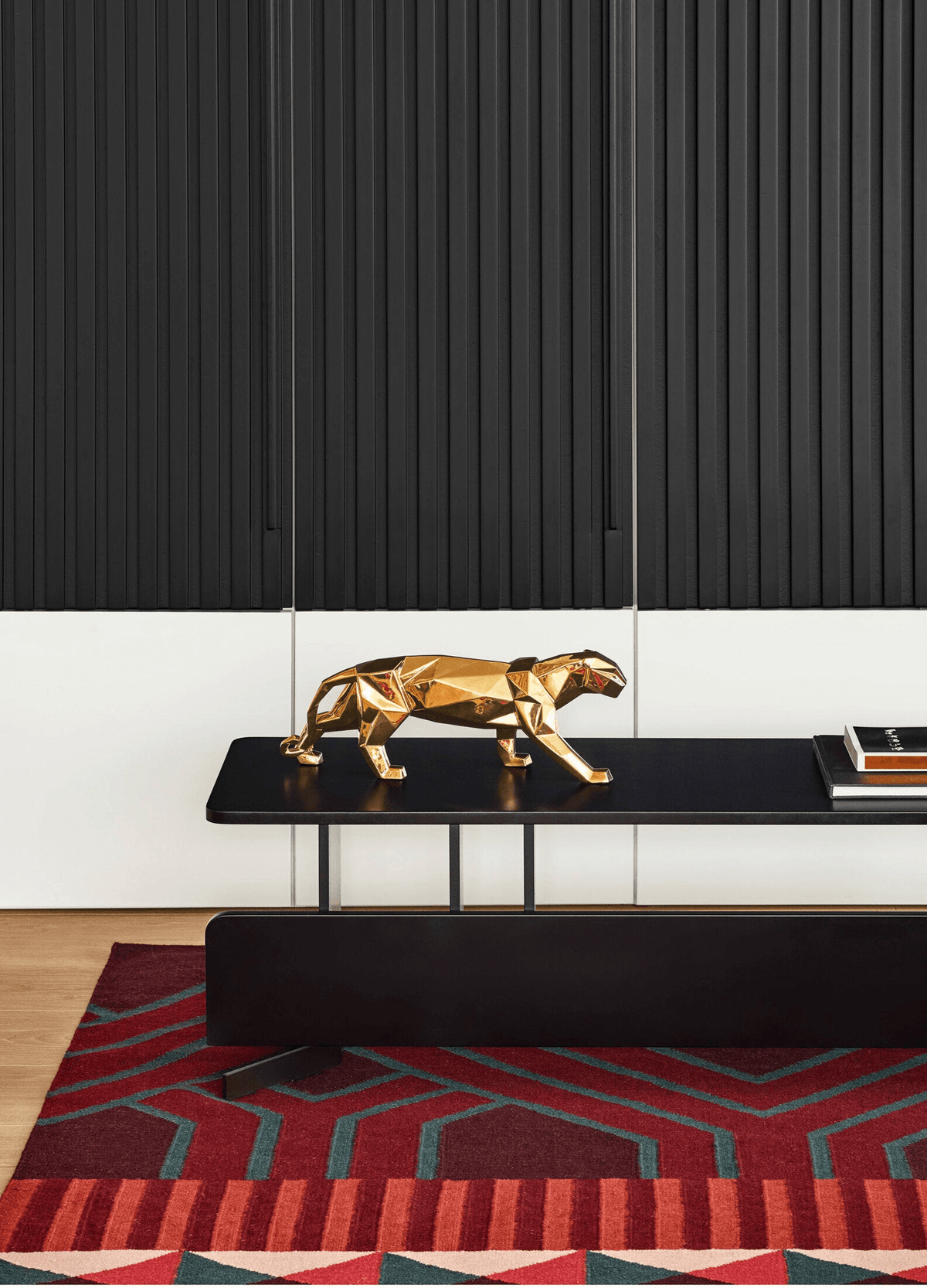 Lladró - Panther Sculpture - Golden displayed on a modern black table with a geometric rug.
