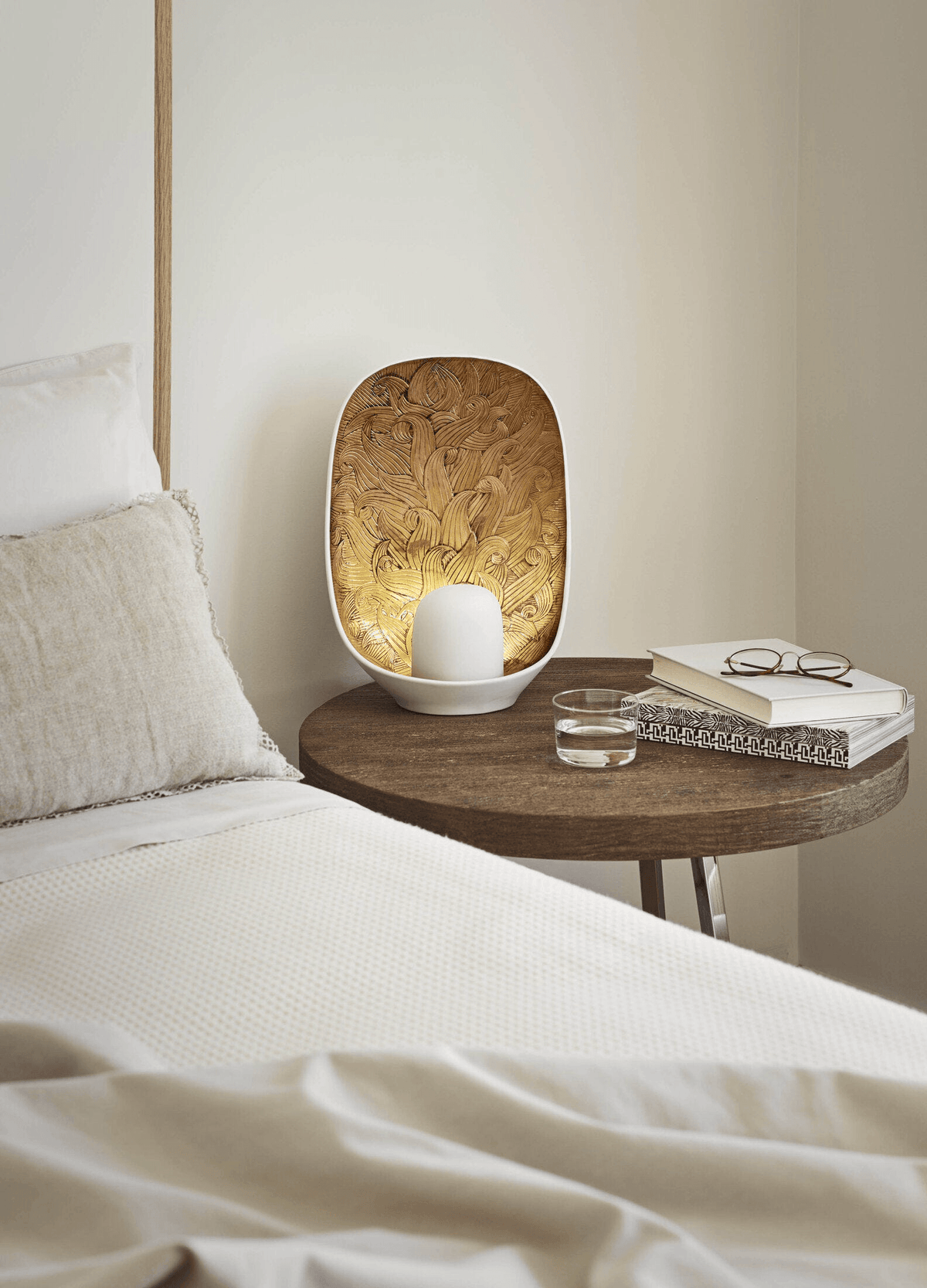 Lladró - Mirage Table Lamp elegantly displayed on a bedside table, featuring porcelain and golden luster details.