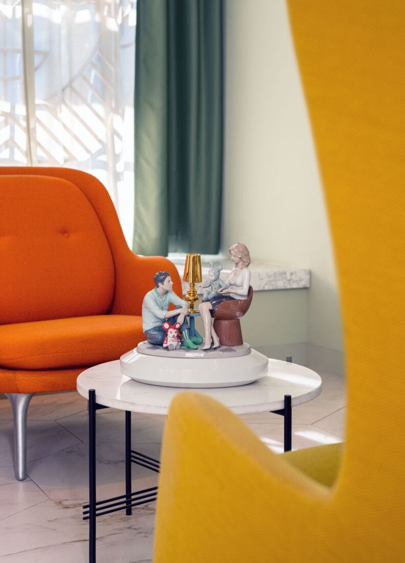 Lladró - The Family Portrait Sculpture displayed on a modern coffee table in a stylish living room.