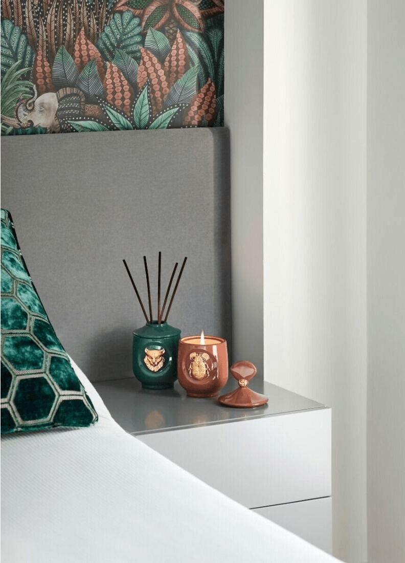 Lladró - Lynx candle Luxurious animals - Redwood fire Scent displayed on a bedside table with decorative porcelain holders.