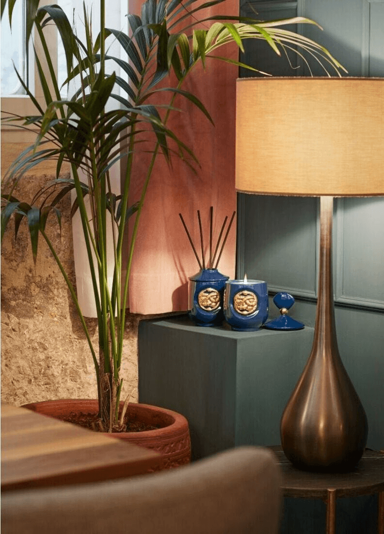 Lladró - Snake Perfume diffuser Luxurious animals - A Secret Orient Scent displayed with decor and plants.