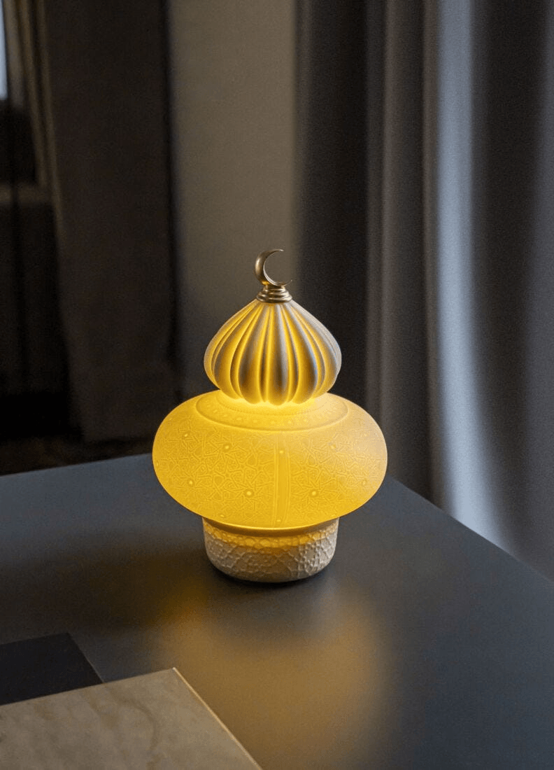 Lladró - Majestic Nights wireless Lamp - Champagne illuminating a table with warm light and intricate design.