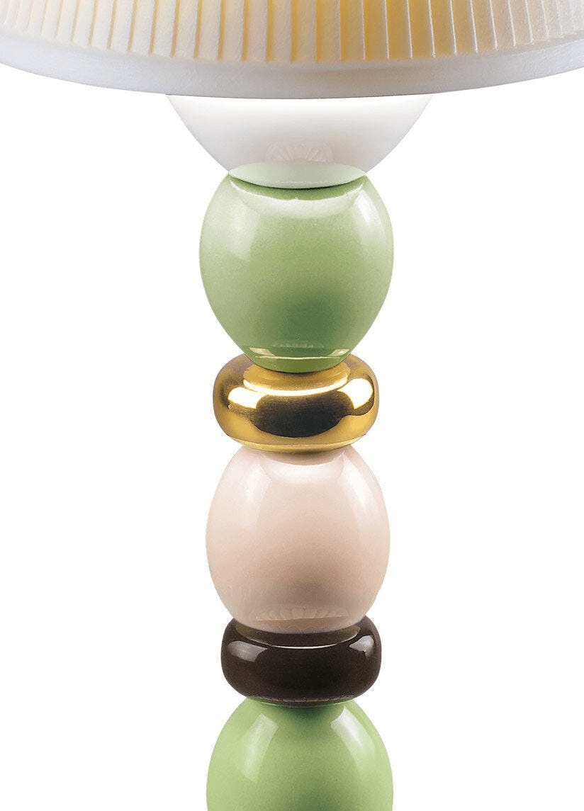 Close up of the Lladro porcelain stem on the Lladró - Palm Firefly Golden Fall Table Lamp - Green and Blue.