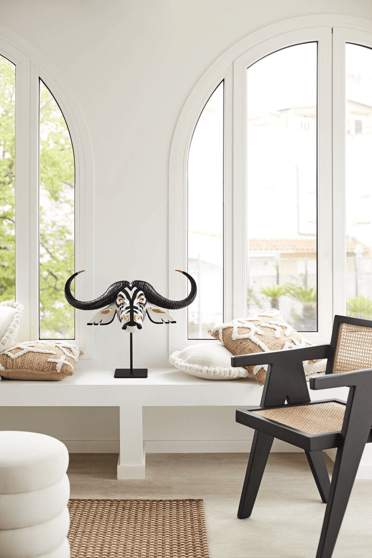 Lladró - Buffalo Mask - Black and Gold displayed in a bright interior with windows and modern furniture.