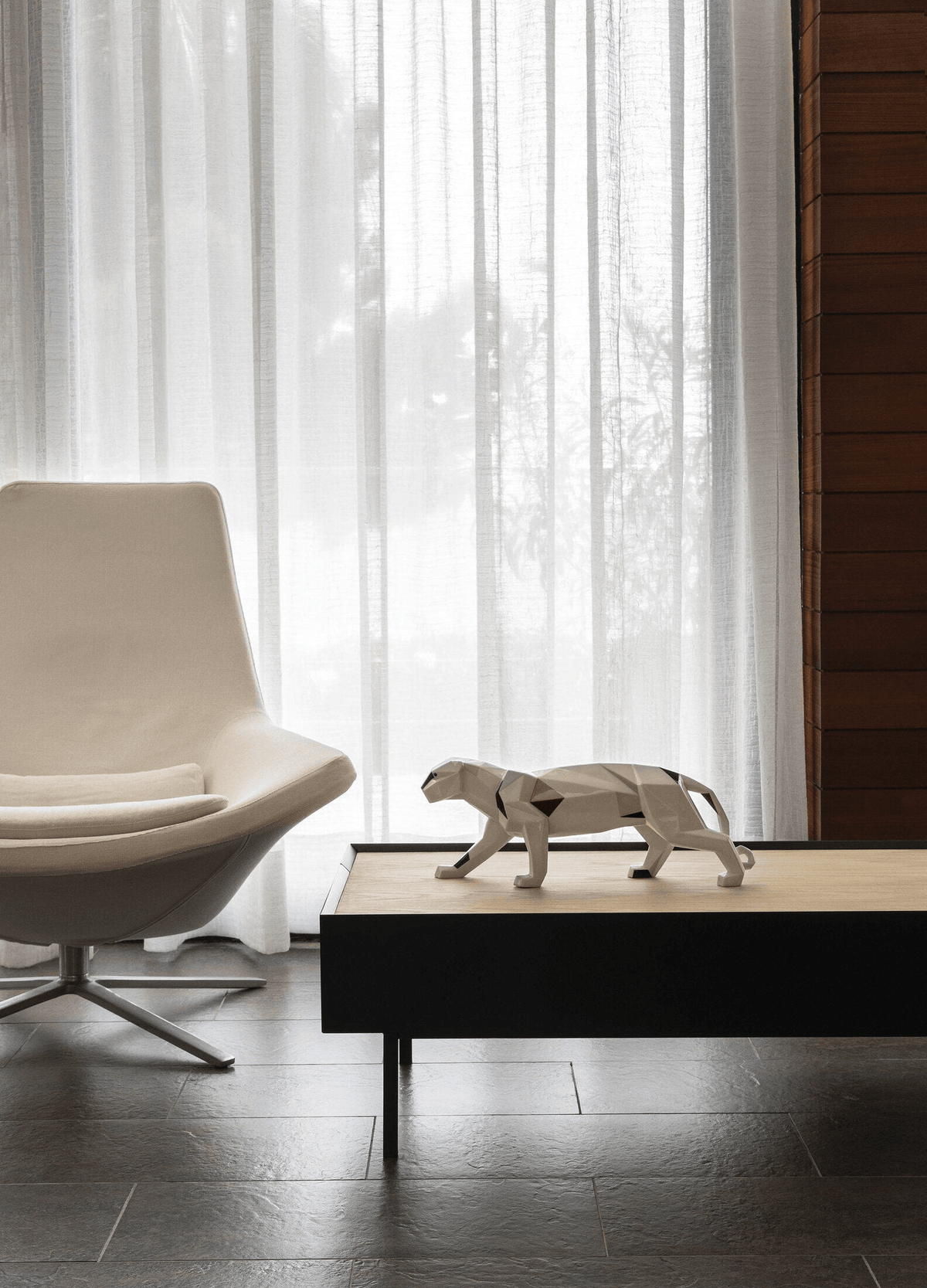 Lladró - Panther Sculpture displayed on a coffee table in a modern living room setting.