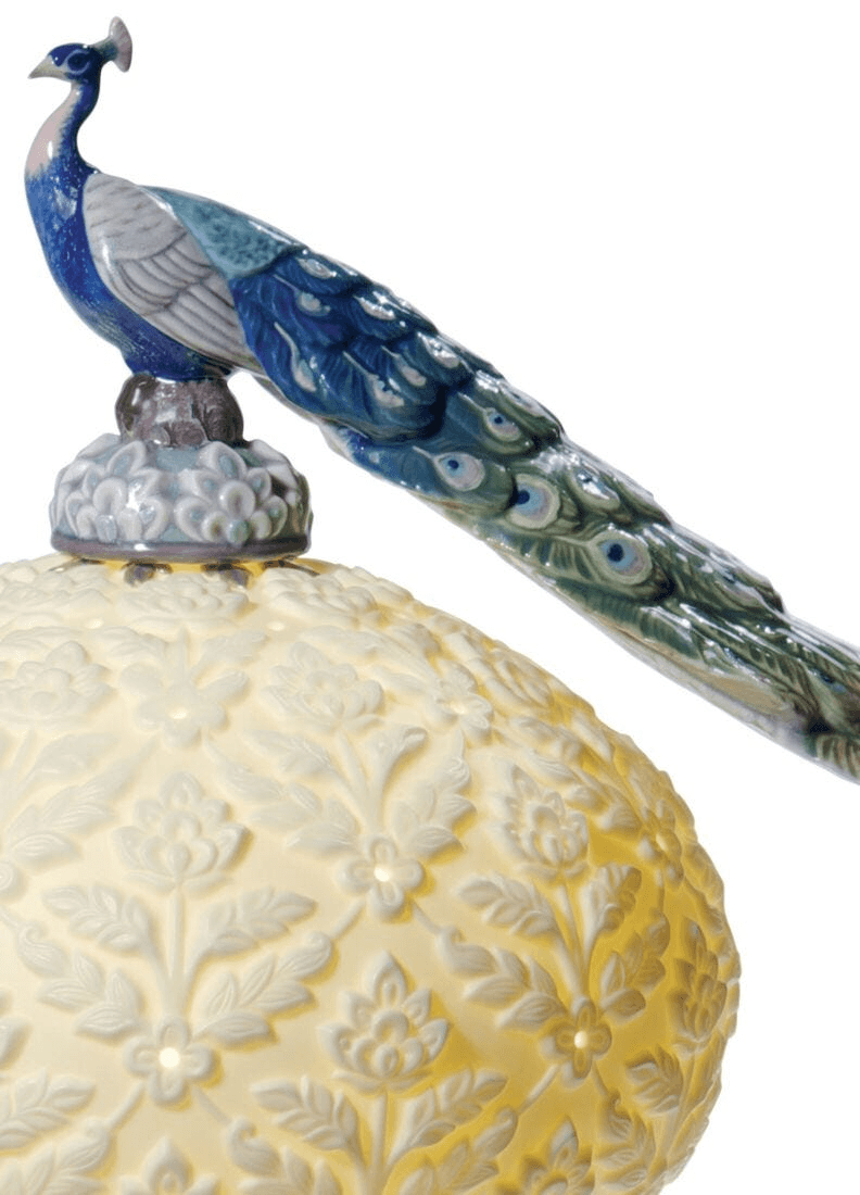 Lladró - Peacock Table Lamp showcasing exquisite porcelain craftsmanship and a vibrant peacock figurine.