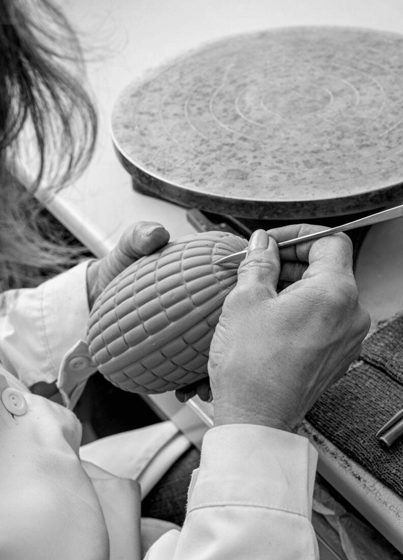 Artisan crafting a porcelain piece for Lladró - Soft Blown Chandelier - Pink with precision.