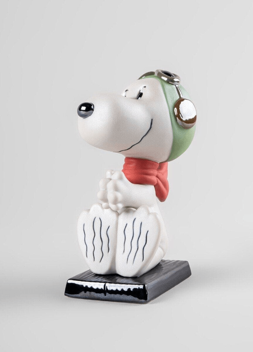 Lladró - Snoopy™ Flying Ace Figurine in satin white porcelain with red scarf and green pilot hat.