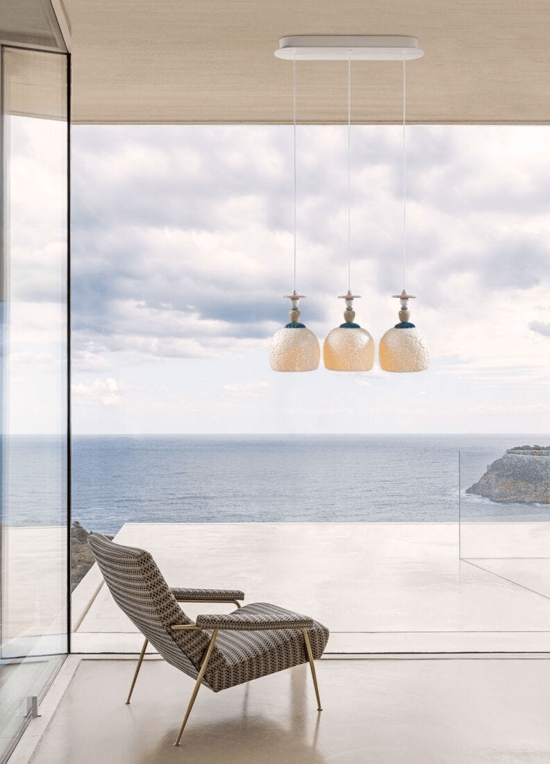 Lladró - Mademoiselle Lineal Canopy 3 Lights Gazing at The Ocean Pendant Light in a modern setting with ocean view.